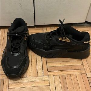 Puma sleek Black and Gold Sneakers with Chunky Soles